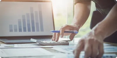 Accountant working with a calculator and a pen